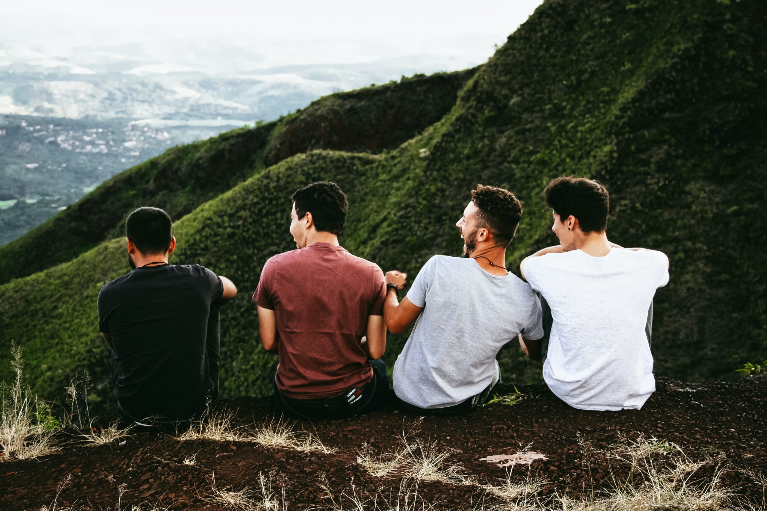 friends4 guys sitting on a mountain