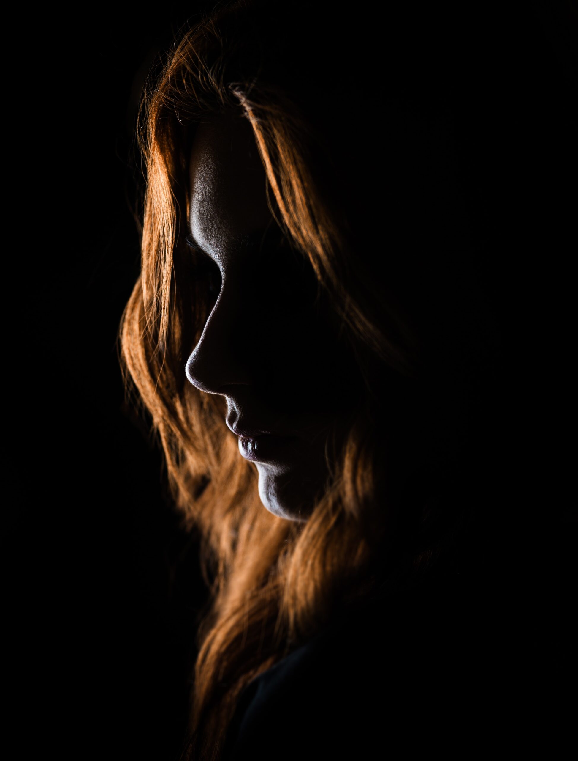 a woman's face in shadow