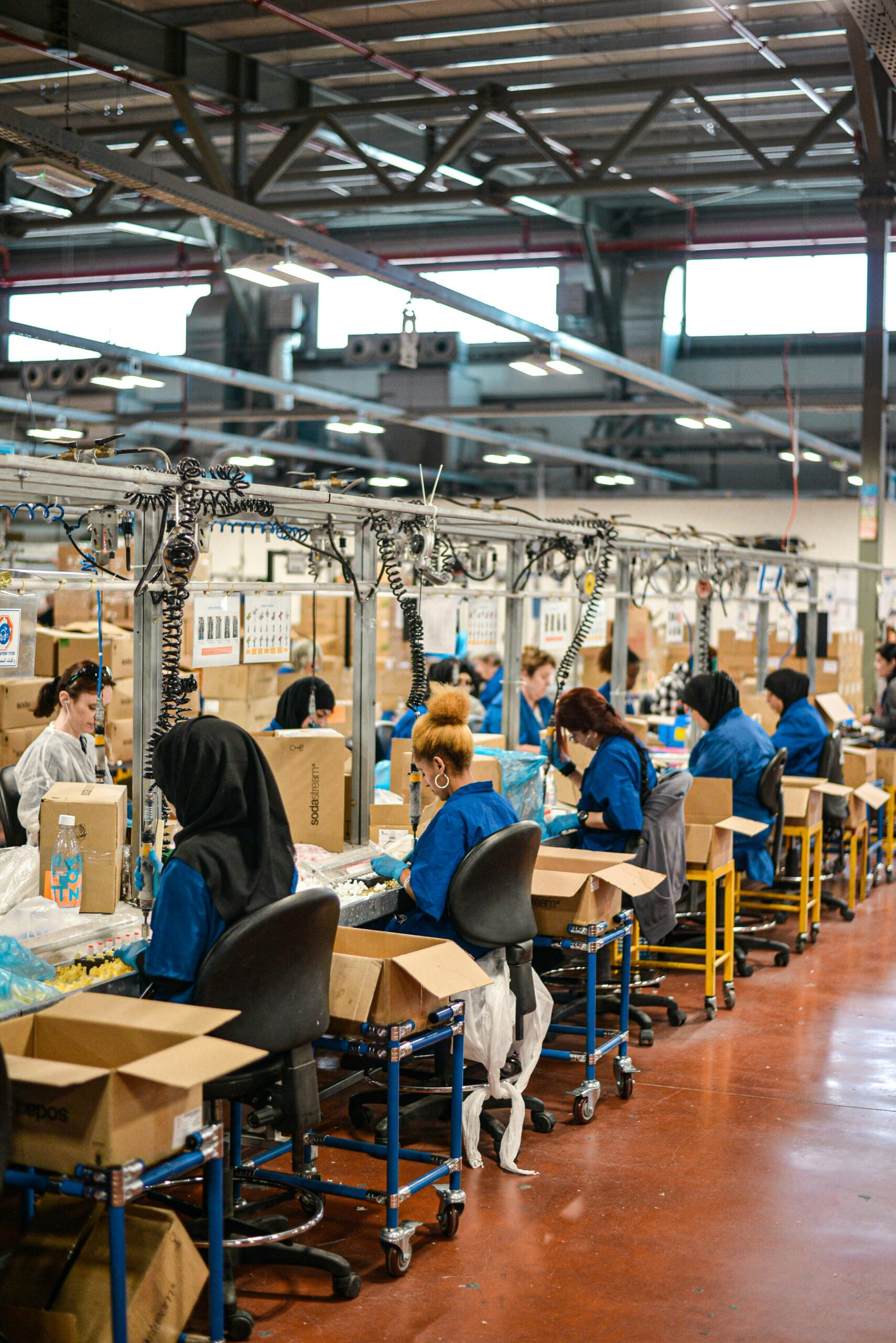 assemblyline4 workers on an assembly line