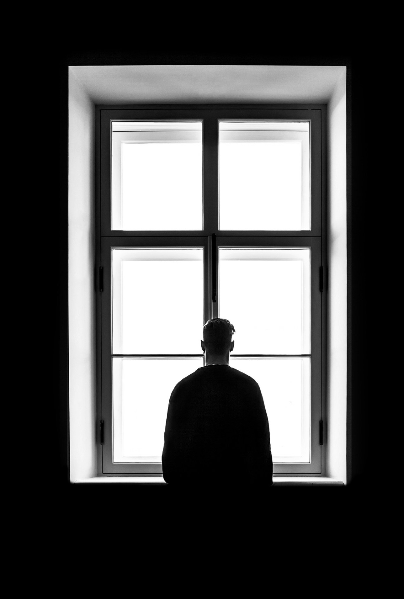 Man standing at a window.